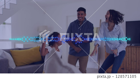 Image of happy biracial family dancing over light spots Image of happy biracial family dancing over light spots 128571105