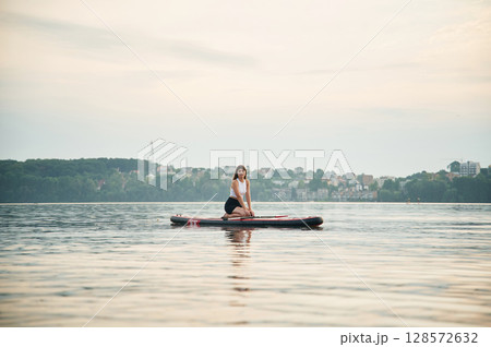 Young woman is on sup boards in the lake 128572632