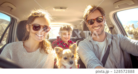 A joyful family, including parents, a child, and a small dog, all wearing sunglasses and smiling broadly from inside a sunlit car, capturing a happy road trip moment A joyful family, including parents, a child, and a small dog, all wearing sunglasses and smiling broadly from inside a sunlit car, capturing a happy road trip moment 128572888