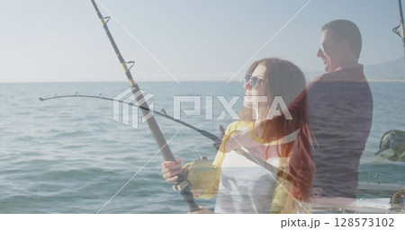 Image of caucasian woman fishing with caucasian man fishing and sea 128573102