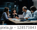 Modern office team meeting with presentation screen and professional executives brainstorming 128573843