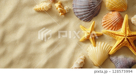 A beautiful arrangement of assorted seashells and starfish artfully scattered on a bed of clean, yellow sand, creating a serene and natural background ideal for summer and beach-themed designs 128573994