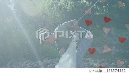 Image of hearts moving over caucasian man picking up rubbish on sunny day in countryside Image of hearts moving over caucasian man picking up rubbish on sunny day in countryside 128574531