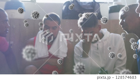 Image of virus cells floating over diverse group of male football players in changing room Image of virus cells floating over diverse group of male football players in changing room 128574683