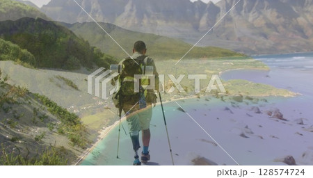 Composite image of a beach against african american man hiking on the mountains 128574724