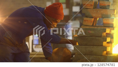 Image of light spots over african american male worker in workshop Image of light spots over african american male worker in workshop 128574781