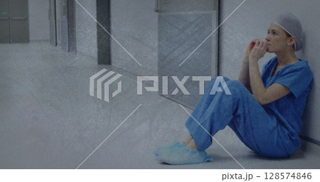 Image of moving shapes over sad caucasian female nurse sitting in hospital Image of moving shapes over sad caucasian female nurse sitting in hospital 128574846