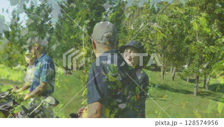 Image of trees over senior caucasian couple playing golf on golf course Image of trees over senior caucasian couple playing golf on golf course 128574956