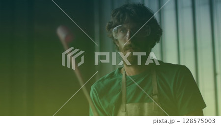 Image of caucasian male worker with safety goggles in workshop 128575003