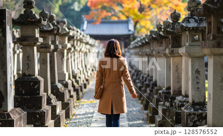 神社仏閣の境内の中を歩く女性の後ろ姿 神社仏閣の境内の中を歩く女性の後ろ姿 128576552
