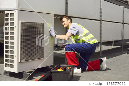Worker Performing Hvac Maintenance And Repair On Air Conditioning System On Roof Worker Performing Hvac Maintenance And Repair On Air Conditioning System On Roof 128577021