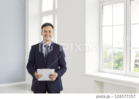 Realtor, happy smiling professional male licensed real estate agent, advertising property, helping  128577257