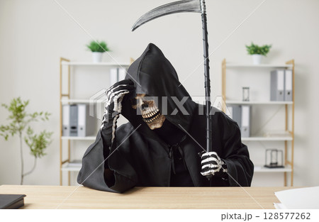 Confused Grim Reaper Working And Thinking At Office Desk Confused Grim Reaper Working And Thinking At Office Desk 128577262