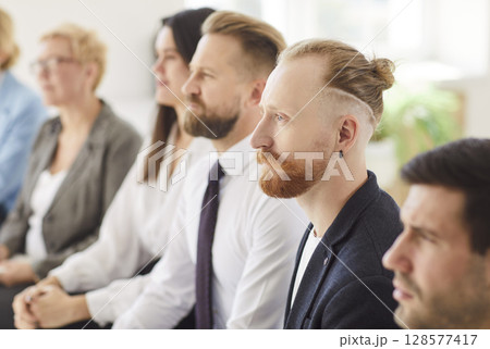 Professionals Engaged in Discussion During a Workshop in a Modern Office Setting Professionals Engaged in Discussion During a Workshop in a Modern Office Setting 128577417