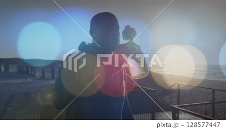 Image of spots over african american man drinking water outdoors Image of spots over african american man drinking water outdoors 128577447