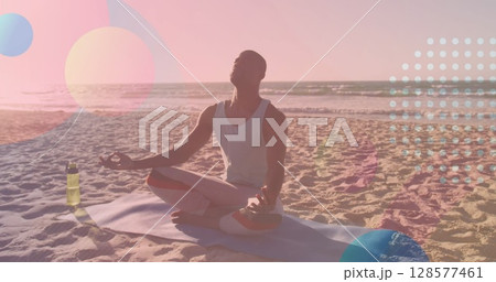 Image of shapes over african american man meditating at beach 128577461