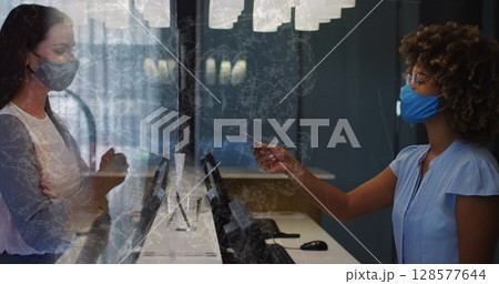 Image of shapes over african american female receptionist with face mask 128577644