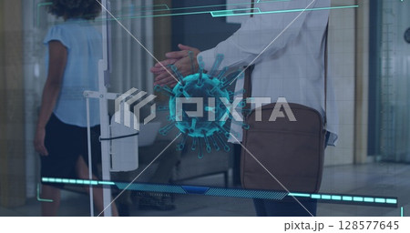 Image of coronavirus cell over caucasian man disinfecting hands 128577645