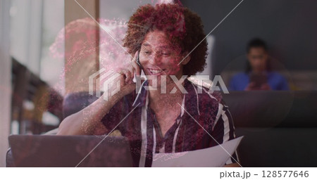 Image of spots over caucasian businessman talking on smartphone 128577646
