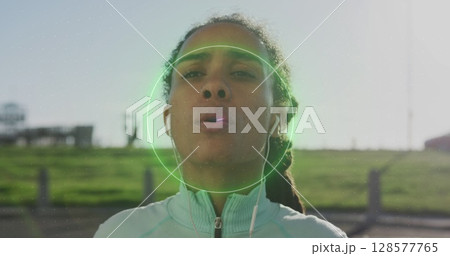 Image of shapes moving over biracial woman breathing in park 128577765