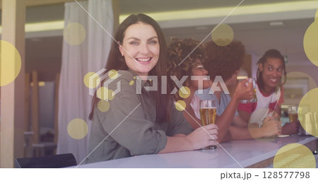 Image of light spots over happy diverse friends drinking beer 128577798