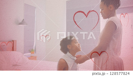 Image of hearts falling over african american woman and her daughter 128577824