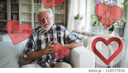 Image of heart icons over senior caucasian man in pain holding his chest 128577836
