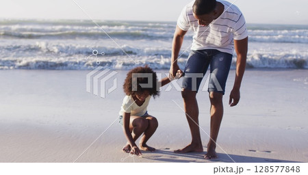Image of molecules over african american afather and son picking up shells on beach at sunset 128577848