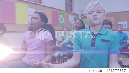 Image of light spots over diverse schoolchildren practicing yoga and meditating Image of light spots over diverse schoolchildren practicing yoga and meditating 128577857