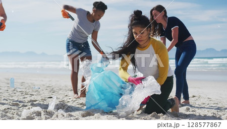 Image of globe icons over diverse female volunteers picking up rubbish on beach Image of globe icons over diverse female volunteers picking up rubbish on beach 128577867