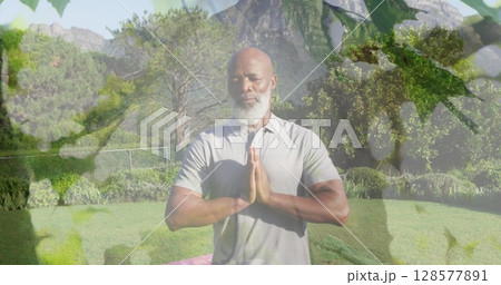 Image of leaves over senior african american man practicing yoga and meditating Image of leaves over senior african american man practicing yoga and meditating 128577891