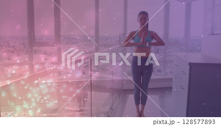 Image of light spots over caucasian woman practicing yoga and meditating Image of light spots over caucasian woman practicing yoga and meditating 128577893