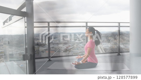 Image of walking people over asian woman practicing yoga and meditating 128577899