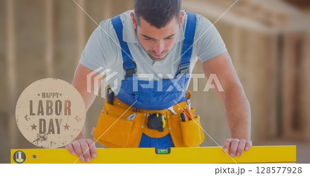 Image of happy labor day text over caucasian worker holding spirit level Image of happy labor day text over caucasian worker holding spirit level 128577928