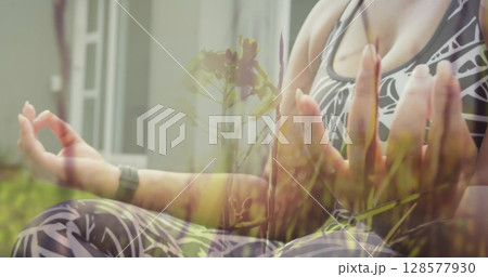 Image of grass over caucasian woman practicing yoga and meditating at home Image of grass over caucasian woman practicing yoga and meditating at home 128577930