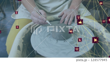 Image of network of connections with icons over caucasian woman doing pottery 128577945