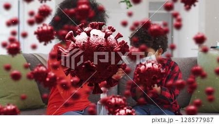 Image of virus cells over african american mother and son with face masks 128577987