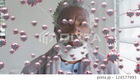 Image of virus cells over senior african american man with face mask 128577993