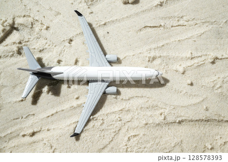 Airplane on a beautiful sandy beach. Natural background. Summer concept. Top view Airplane on a beautiful sandy beach. Natural background. Summer concept. Top view 128578393