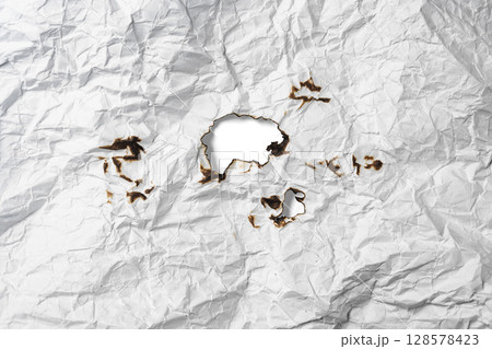 Burnt hole on crumpled sheet of white paper on a white background. Creased and wrinkled paper surface. Copy space 128578423