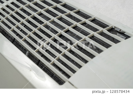 Closeup view of an Air conditioner or AC indoors on a white wall background Closeup view of an Air conditioner or AC indoors on a white wall background 128578434