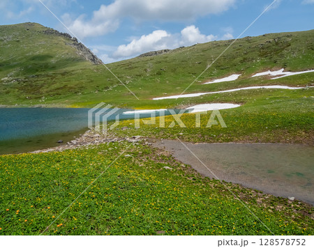 Small mountain lake in sunny green valley. Small mountain lake in sunny green valley. 128578752