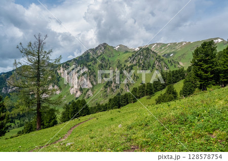Footpath through valley in highland. Hiking path. 128578754