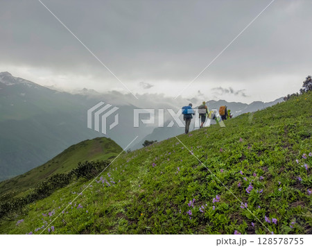Hiking in the mountains. Group of hikers Hiking in the mountains. Group of hikers 128578755