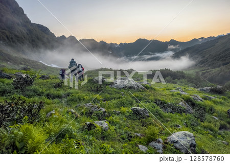 Hiking in the mountains. Group of hikers Hiking in the mountains. Group of hikers 128578760