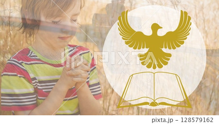 Image of bible icon over caucasian boy praying Image of bible icon over caucasian boy praying 128579162
