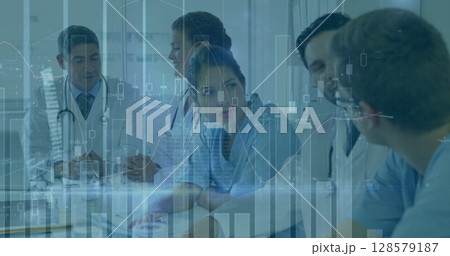 Image of graphs and data over diverse female and male doctors during consultation 128579187