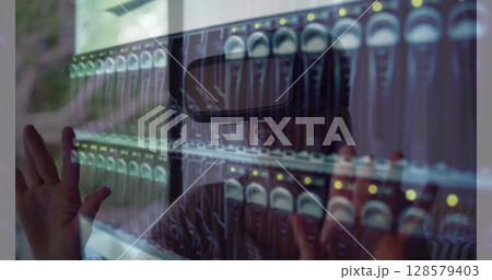 Image of women using vr headset over server room 128579403