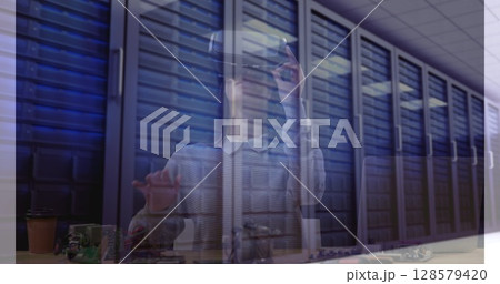 Image of women using vr headset over server room 128579420