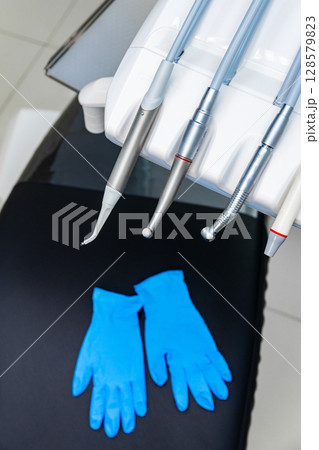 Modern Dental Clinic Equipment with Professional Instruments and Clean Blue Gloves Ready for Use in a Sterile Environment Designed for Patient Comfort 128579823